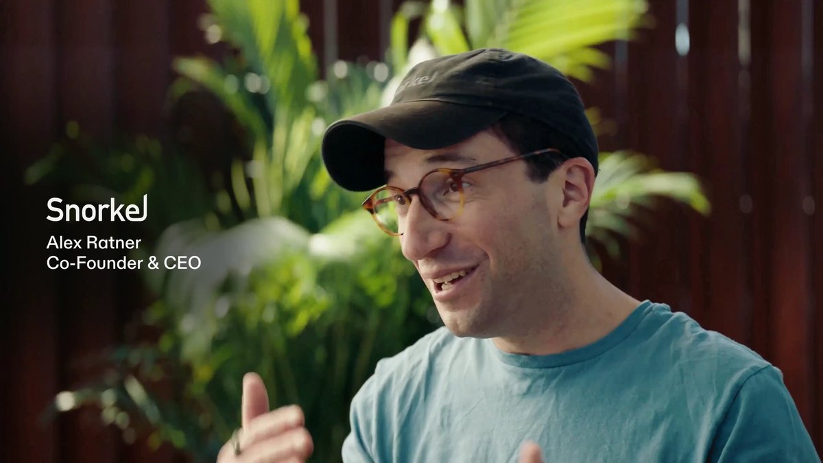 Still from Modal's Series D video: Alex Ratner, Snorkel's cofounder and CEO, interviewed in front of plants and a wooden slat wall, with a Snorkel lower-third